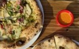 Wood-fired pizzas on a table at BUCO Pizzeria